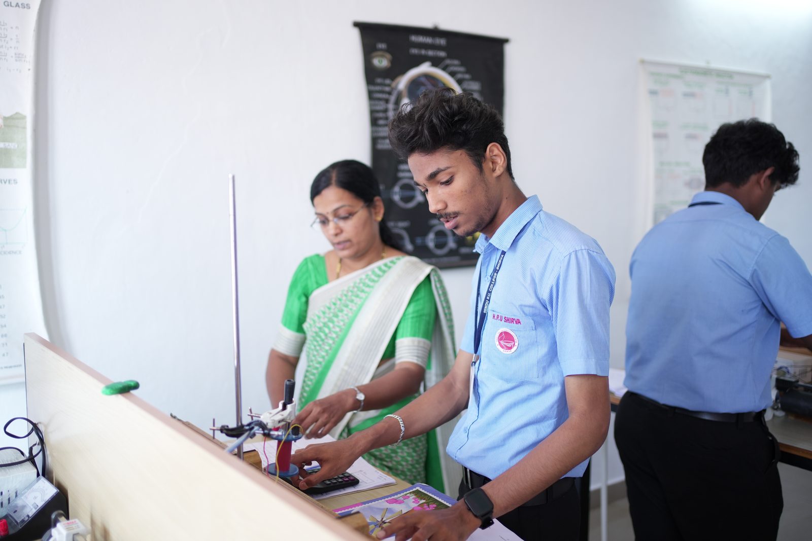 Student performing an experiment with a lecturer